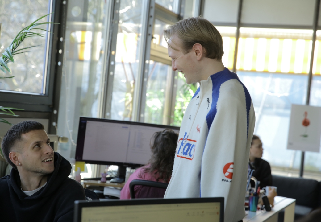 Kollegen im Austausch über Gehaltsabrechnung im Büro